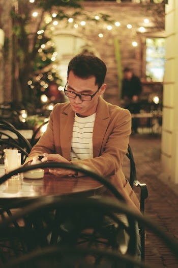 Man Sitting on Chair Beside Table