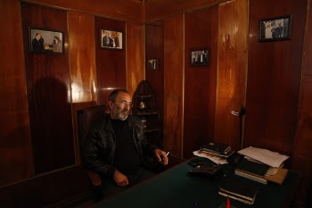 Man Sitting On Chair In Front Of Table
