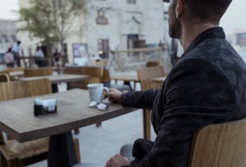 Man Sitting on Chair Infront of Table