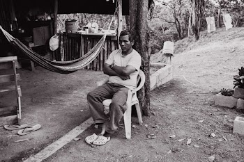 Man Sitting on Chair Near Hammock in Grayscale Photo