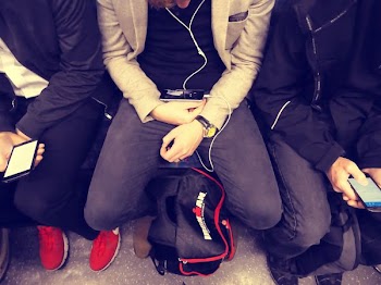Man Sitting on Chair Wearing Earphones