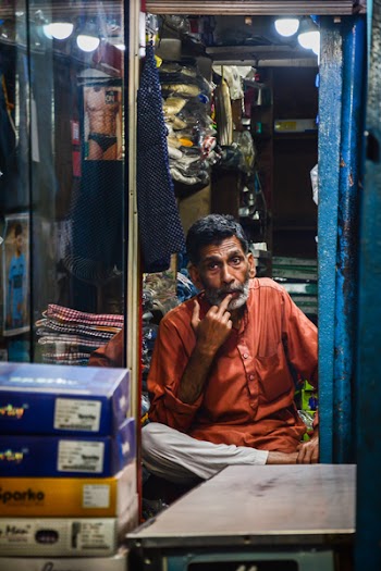 Man Sitting on Chair While Putting His Finger on Lips