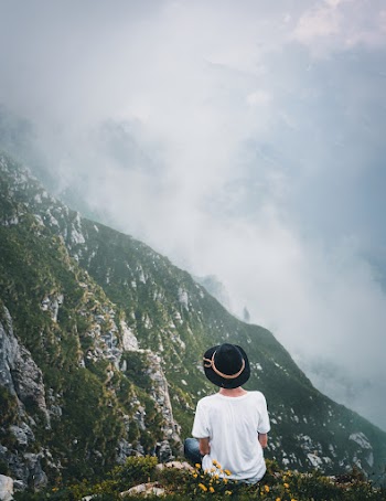 Man Sitting on Cliff