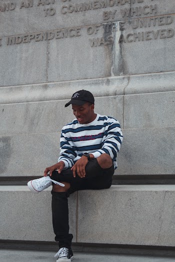 Man Sitting on Concrete Bench