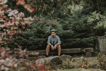 Man Sitting On Concrete Bench