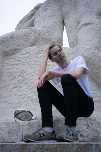 Man Sitting on Concrete Block