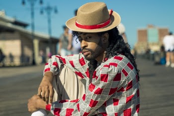 Man Sitting on Concrete Ground Wearing Hat