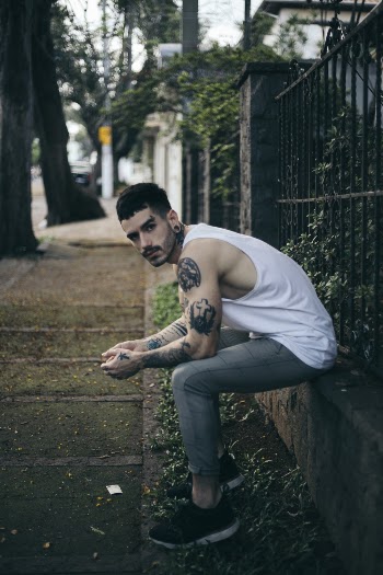 Man Sitting on Concrete Stone