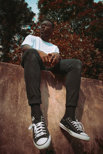 Man Sitting on Concrete Surface