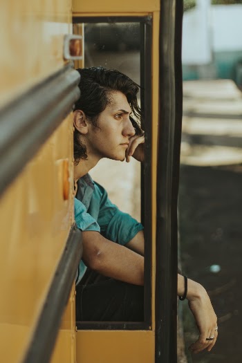 Man Sitting on Door of School Bus