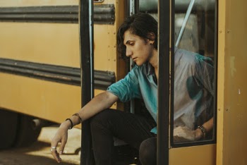 Man Sitting on Door of School Bus