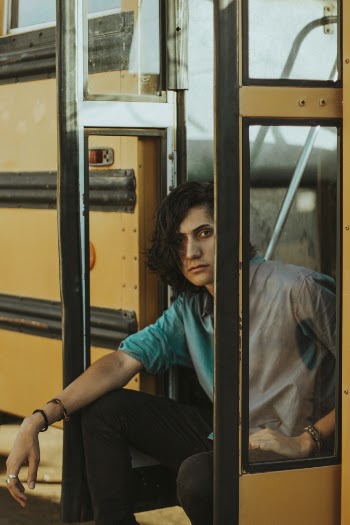 Man Sitting on Doorway of School Bus