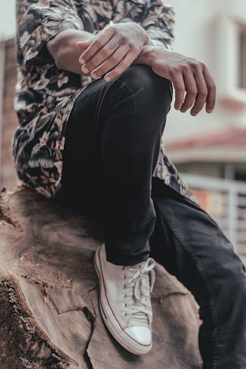 Man Sitting on Drift Wood