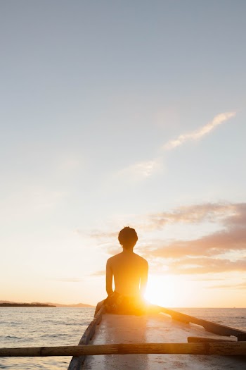 Man Sitting On Edge Of Boat 