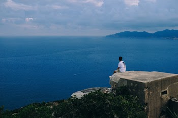 Man Sitting on Edge of Roof