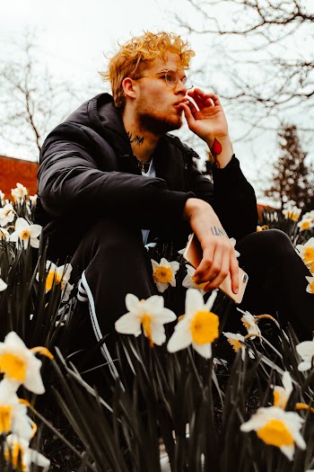 Man Sitting on Field of Flowers