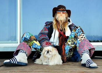 man sitting on floor beside dog during daytime
