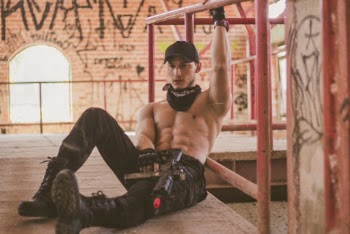 Man Sitting On Floor Holding On Handrail Holding Toy Rifle