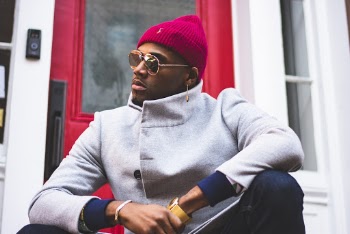 Man Sitting on Front of Red Halflite Door