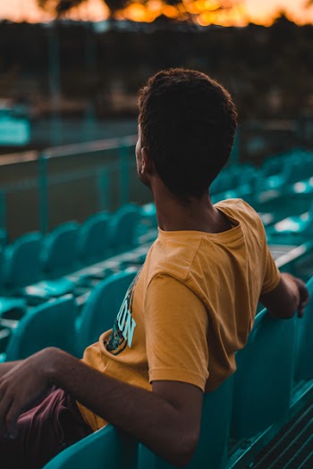 Man Sitting on Gang Chair