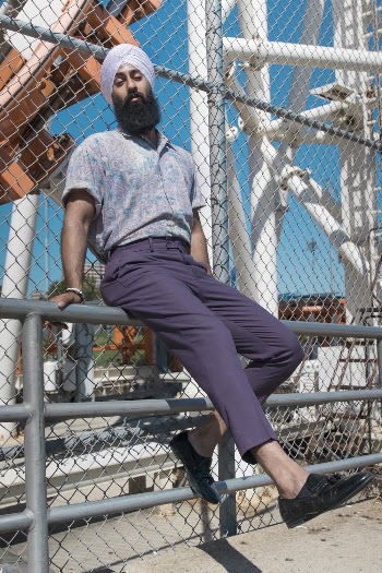 Man Sitting on Gray Metal Handrail