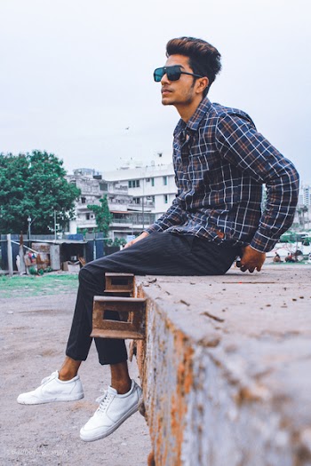 Man Sitting on Gray Metal Utility Trailer