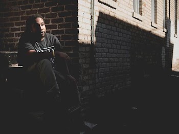 man sitting on gray staircase