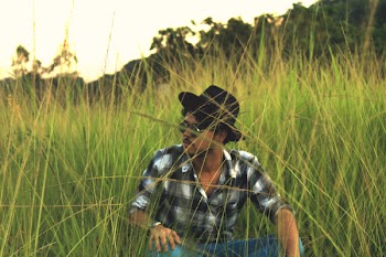 Man Sitting on Green Grass Field