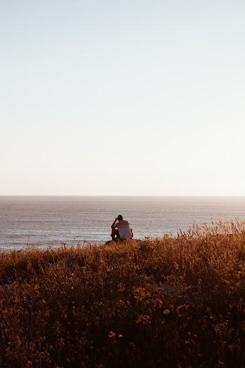 Man Sitting On Ground