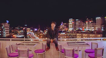 Man Sitting on Hand Rail