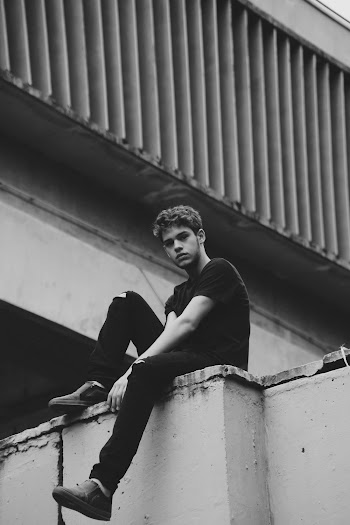 Man Sitting on Ledge