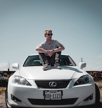 Man Sitting on Lexus Vehicle
