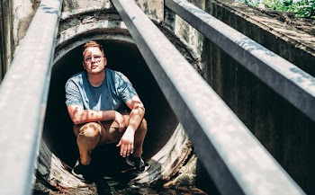 Man Sitting on Manhole