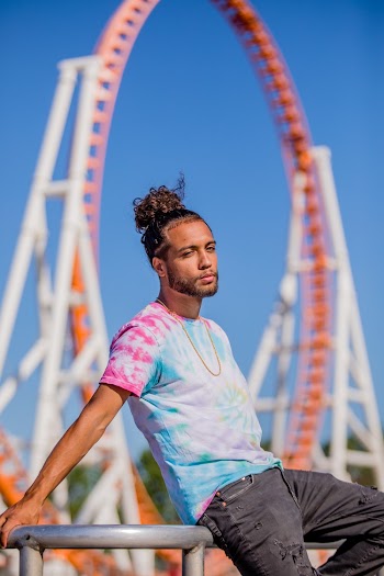 Man Sitting On Metal Railing