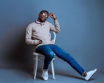 Man Sitting on Monobloc Chair