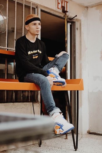 man sitting on orange bench