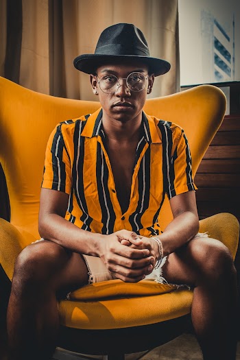 Man Sitting On Orange Chair