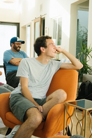 Man Sitting On Orange Chair