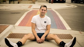 Man Sitting on Pavement