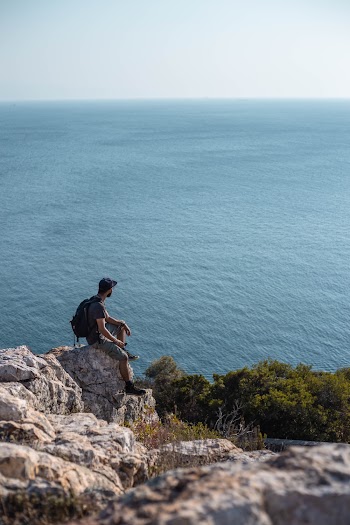 Man Sitting On Rock
