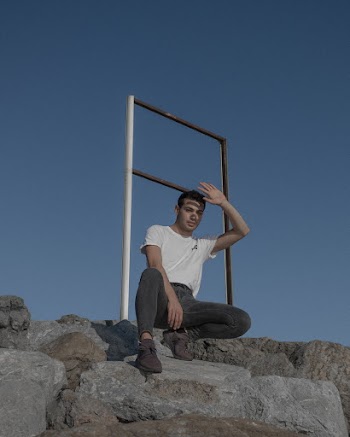 Man Sitting on Rock