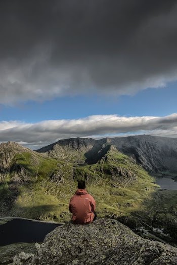 man sitting on rock