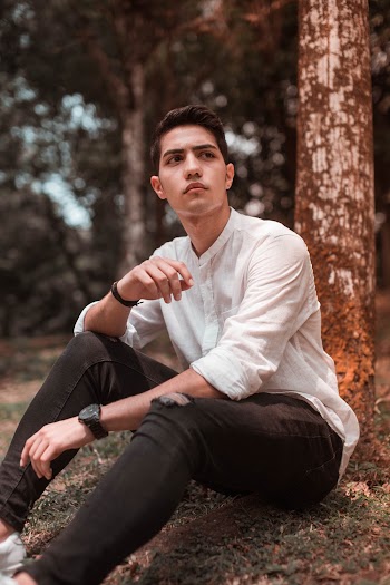 Man Sitting on Rock Beside Tree