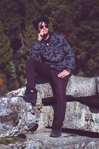 Man Sitting on Rock Formation