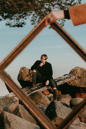 Man Sitting on Rock With Frame