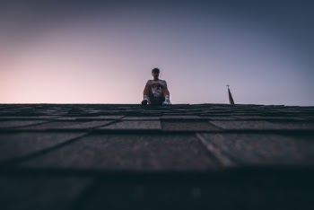 Man Sitting On Roof