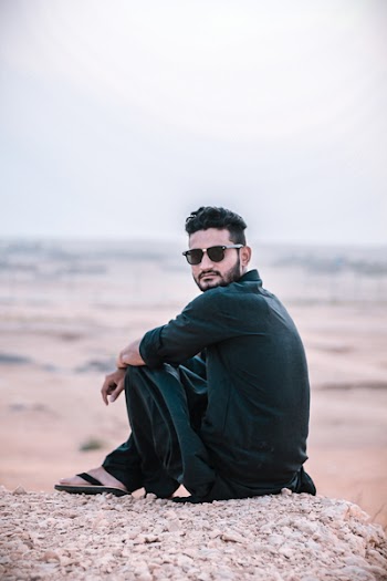 Man Sitting on Sand