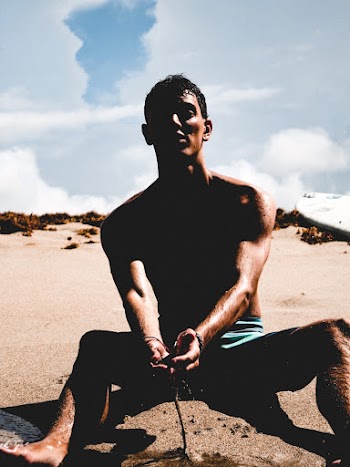 Man Sitting on Sand