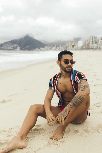 Man Sitting on Sand at Beach
