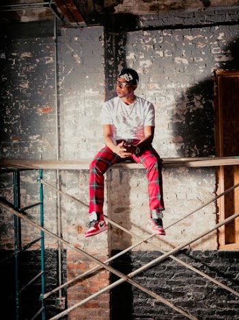 Man Sitting On Scaffolding